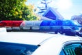 Red light flasher of a patrol police car in the neighborhood. Security siren of the Canadian police vehicle. Day patrolling of the Royalty Free Stock Photo