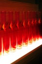 Red light illuminated glass bottles abstract background