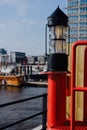 Red light lantern in HafenCity. ght. Port piers with ships and yacht at anchor in background. Hamburg, Germany