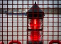 The red light of a lighthouse on the banks of the Elbe in Finkenwerder.