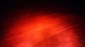 Red light over a wooden surface creating a artistic colored texture