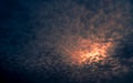 Red light of sun in dark cloudy sunset sky. Dramatic sky with beautiful pattern of fluffy clouds. Mental power or psychic power Royalty Free Stock Photo