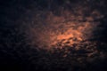 Red light of sun in dark cloudy sunset sky. Dramatic sky with beautiful pattern of fluffy clouds. Mental power or psychic power Royalty Free Stock Photo