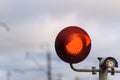 Red light at the traffic light at the railway crossing. Close up. Royalty Free Stock Photo