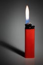 Red lighter with burning fire