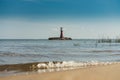 Red lighthouse with a beach Royalty Free Stock Photo
