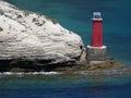 Red lighthouse and limestone cliffs, mediterranean sea, view from Bonifacio. Corsica Island, France x Royalty Free Stock Photo