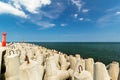 Red lighthouse next to the breakwater, Baltic Sea Royalty Free Stock Photo