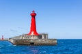 Red lighthouse over concrete pier in Hualien harbor of Taiwan Royalty Free Stock Photo