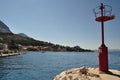 Red lighthouse in port. Podgora, Croatia