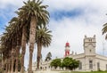 Red lighthouse, white German fort and row of palms, of colonial town of Swakopmund Royalty Free Stock Photo