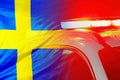 Red lights on top of Sweden police car on the background of the Sweden flag