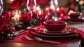 Red linens, elegant dinnerware, and romantic candlelight