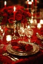 Red linens, elegant dinnerware, and romantic candlelight