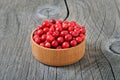 Red lingonberry in wooden bowl