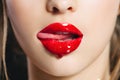 Red lip gloss. Closeup mouth with tongue. Saturated color