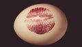 Red lip imprint on easter egg on black background. Print of red lips on white egg. Egg hunt. Royalty Free Stock Photo