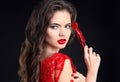 Red lips. Beautiful brunette girl portrait holding heart gift for Valentines Day. Sensual woman with long hair style isolated on Royalty Free Stock Photo