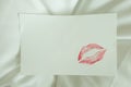 Red lips kiss blank white note good morning message on bed Royalty Free Stock Photo