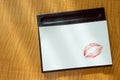 Red lips kiss white blank note morning message on table Royalty Free Stock Photo