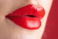 Red lipstick. Glossy make-up for plump natural lips. Lipstick and pomade. Close up red lips. Pink lipstick. Pomade