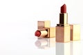 Red lipstick in golden box.