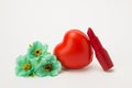 Red lipstick, heart and necklace with flowers on a white background Royalty Free Stock Photo