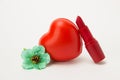 Red lipstick, heart and necklace with flowers on a white background Royalty Free Stock Photo