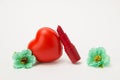 Red lipstick, heart and necklace with flowers on a white background Royalty Free Stock Photo