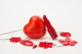 Red lipstick, heart and necklace with flowers on a white backgro Royalty Free Stock Photo