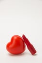 Red lipstick, heart and necklace with flowers on a white background Royalty Free Stock Photo