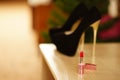 Red lipstick and high heel women shoes on the table Royalty Free Stock Photo