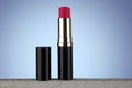 Red lipstick isolated on light blue gradient background Royalty Free Stock Photo