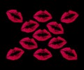 Red lipstick kisses on a black background