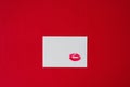 Red lipstick lip print Kiss on white paper sheet on red Royalty Free Stock Photo