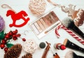 Red lipstick and makeup brushes with christmas decorations on wooden background Royalty Free Stock Photo