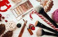 Red lipstick and makeup brushes with christmas decorations on wooden background Royalty Free Stock Photo