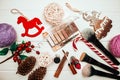 Red lipstick and makeup brushes with christmas decorations on wooden background Royalty Free Stock Photo