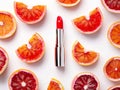 A red lipstick placed half a blood orange slices on a white background Royalty Free Stock Photo