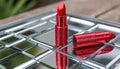 Red lipstick on a shiny surface. Royalty Free Stock Photo