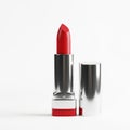 Red lipstick in silver case standing upright on white background for makeup and beauty Royalty Free Stock Photo