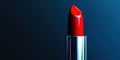 Red lipstick is sitting on a blue background Royalty Free Stock Photo