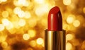 A red lipstick is sitting on a gold background Royalty Free Stock Photo