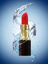 Red lipstick in water splash on blue background