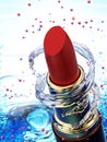 Red lipstick in water splash