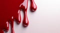 Red Liquid Dripping on a White Surface Royalty Free Stock Photo