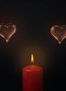 A red lit candle and two transparent hearts on a dark background Royalty Free Stock Photo