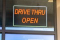 red sign reads drive thru open in restaurant window Royalty Free Stock Photo