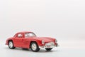 Red little ancient model toy car isolated on background. Royalty Free Stock Photo