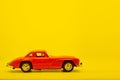 Red little ancient model toy car isolated on background. Royalty Free Stock Photo